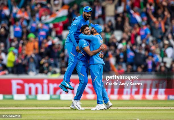 Virat Kohli of India and KL Rahul congratulate Vijay Shankar on taking the wicket of Imam-ul-Haq during the Group Stage match of the ICC Cricket...