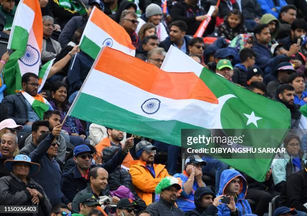 Spectators wave flags during the 2019 Cricket World Cup group stage match between India and Pakistan at Old Trafford in Manchester, northwest...