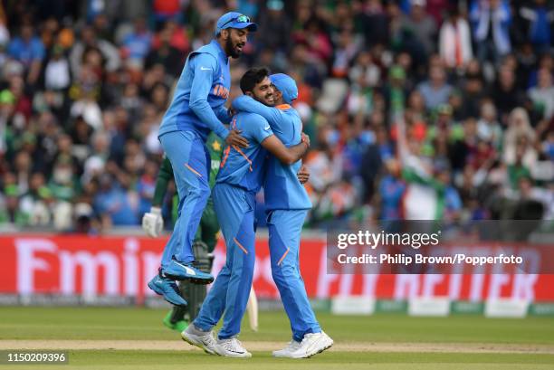 Vijay Shankar is congratulated by KL Rahul and Virat Kohli of India after dismissing Imam-ul-Haq of Pakistan during the ICC Cricket World Cup Group...