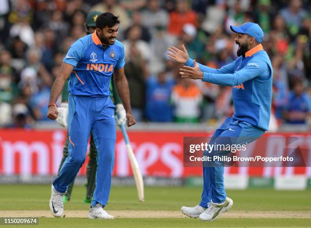 Vijay Shankar is congratulated by Virat Kohli of India after dismissing Imam-ul-Haq of Pakistan during the ICC Cricket World Cup Group Match between...