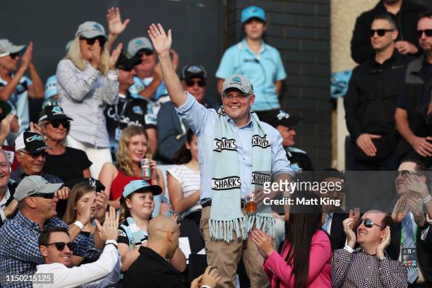 The Prime Minister of Australia Scott Morrison waves to the crowd during the round 10 NRL match between the Cronulla Sharks and the Manly Sea Eagles...