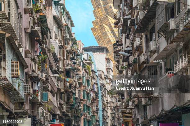 contrast of residential areas and modern buildings in macao - macao fotografías e imágenes de stock