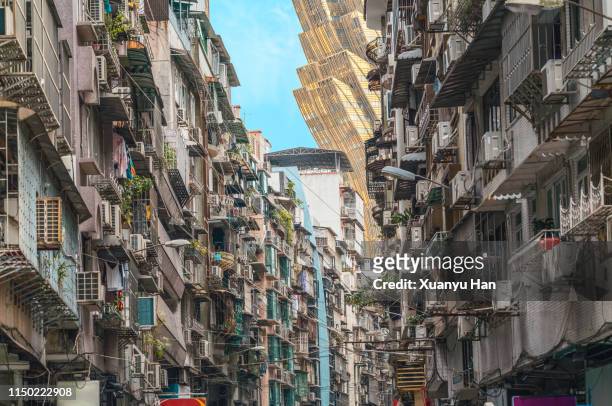 contrast of residential areas and modern buildings in macao - macau stockfoto's en -beelden