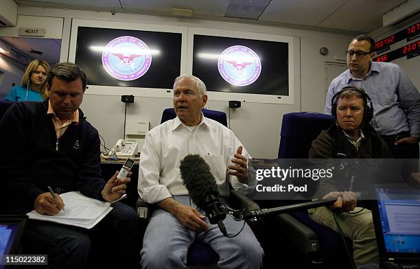 Secretary of Defense Robert Gates speaks to the press aboard his aircraft on June 2, 2011 over the Pacific Ocean between Hawaii and Singapore. Gates...