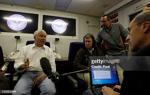 Secretary of Defense Robert Gates speaks to the press aboard his aircraft on June 2, 2011 over the Pacific Ocean between Hawaii and Singapore. Gates...
