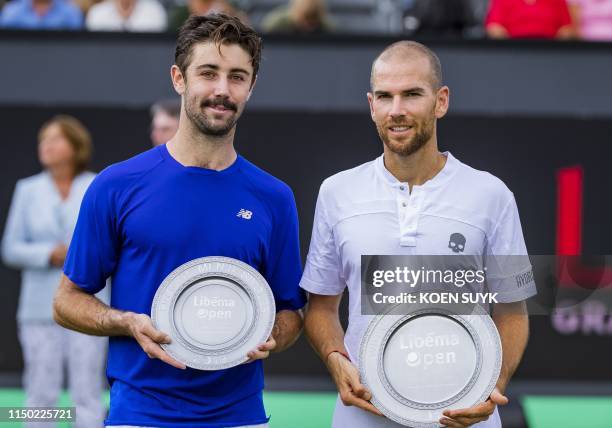 Winner Adrian Mannarino of France and Jordan Thompson of Australia pose with their trophies after their men's final match at the Libema Open tennis...