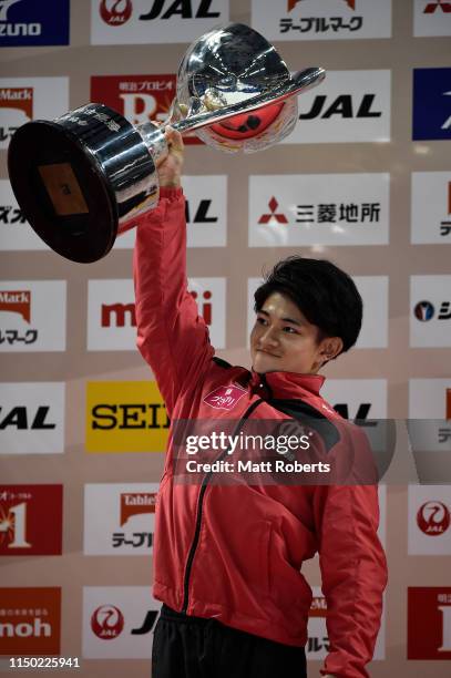 Kakeru Tanigawa of Japan holds the NHK trophy aloft during day two of the Artistic Gymnastics NHK Trophy at Musashino Forest Sport Plaza on May 19,...