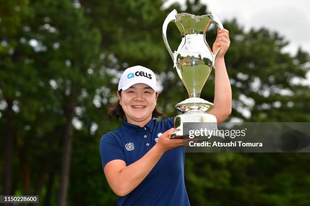 Min-Young Lee of South Korea poses for photographs with the trophy during the award ceremony following the Hoken-no-Madoguchi Ladies at Fukuoka...
