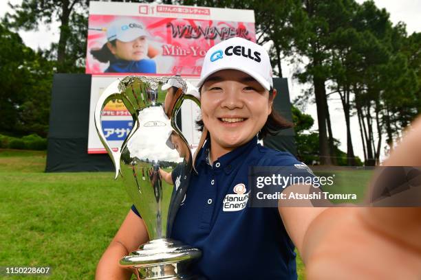 Min-Young Lee of South Korea poses for photographs with the trophy after the award ceremony following the Hoken-no-Madoguchi Ladies at Fukuoka...