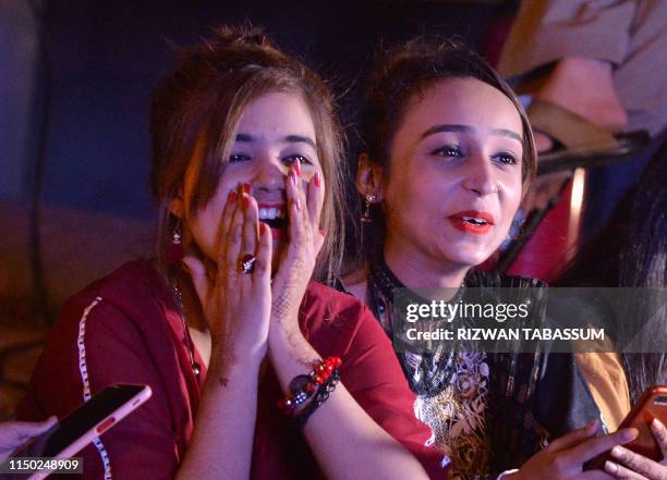 Pakistani woman watch the 2019 Cricket World Cup group stage match between India and Pakistan taking place at Old Trafford, northwest England, on a...