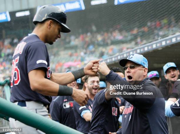 Oscar Mercado of the Cleveland Indians receives a fist bump from manager Terry Francona of the Cleveland Indians after scoring on a home run hit...