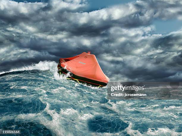 life raft in stormy ocean - lifeboat stock pictures, royalty-free photos & images