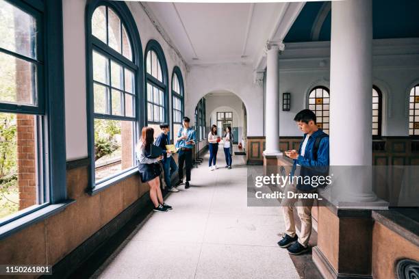 wide angle shot of students and youth in lecture hall in east asia. - college corridor stock pictures, royalty-free photos & images
