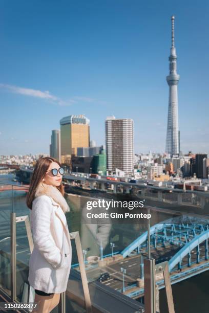 portrait of a female traveler from tokyo high angle near tokyo skytree tower , japan - narita city stock pictures, royalty-free photos & images