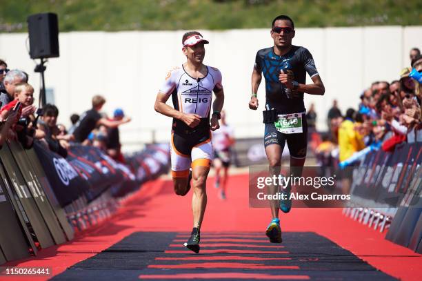 Athletes cross the finish line during IRONMAN 70.3 Barcelona on May 19, 2019 in Calella, Spain.