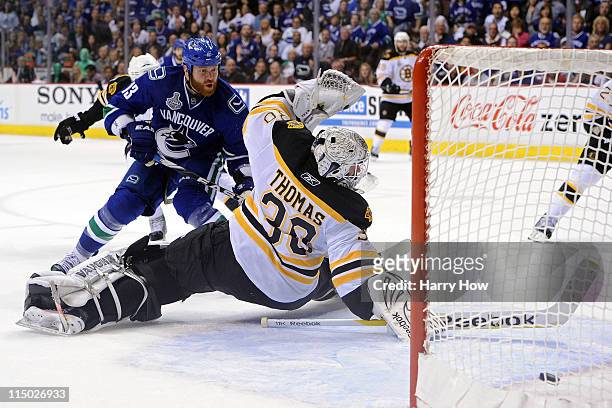 Raffi Torres of the Vancouver Canucks scores a goal late in the third period against Tim Thomas of the Boston Bruins during game one of the 2011 NHL...
