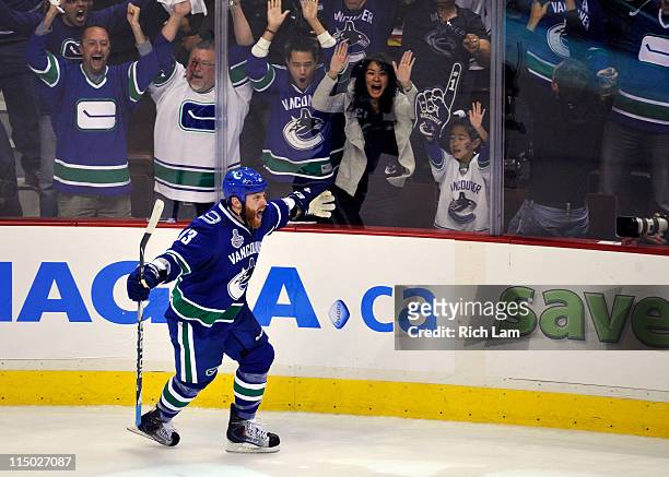 Raffi Torres of the Vancouver Canucks celebrates after scoring a goal late in the third period against Tim Thomas of the Boston Bruins during game...