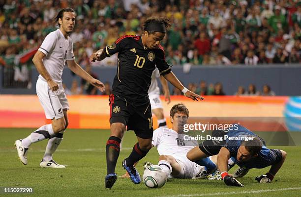 Giovani Dos Santos of Mexico beats Andrew Boyens and goalkeeper Glen Moss of New Zealand for his second goal of the game to give Mexico a 2-0 lead in...
