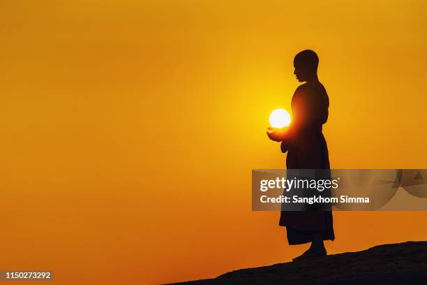 a monk standing meditation. - monk religious occupation stock-fotos und bilder