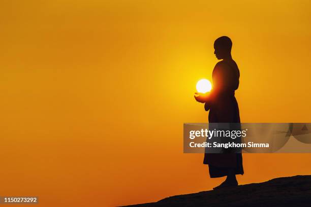 a monk standing meditation. - buddhism stock pictures, royalty-free photos & images