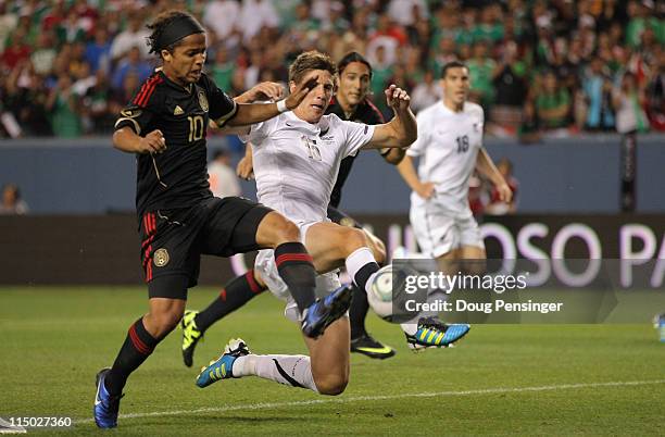 Giovani Dos Santos of Mexico pressures the goal against Andrew Boyens of New Zealand at INVESCO Field at Mile High on June 1, 2011 in Denver,...