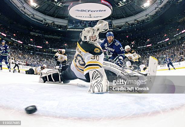 Raffi Torres of the Vancouver Canucks scores with 18 seconds left to go, while Tim Thomas of the Boston Bruins looks on in Game One of 2011 NHL...