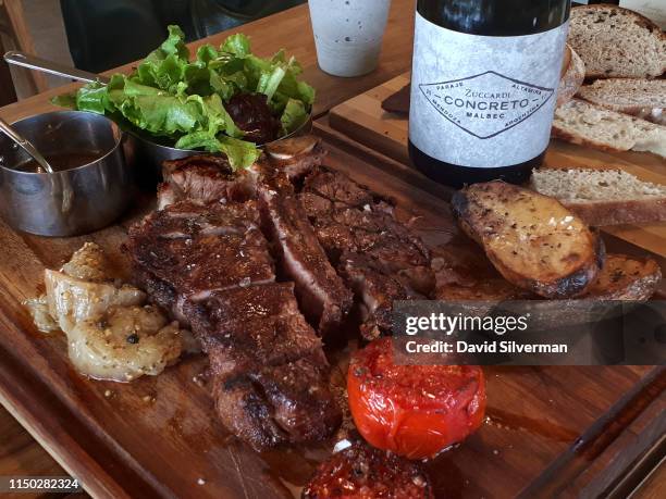 Bodega Zuccardi's Concreto Malbec 2017 vintage red wine is served with traditional charcoal grilled T-Bone steak at the winery's Piedra Infinita...