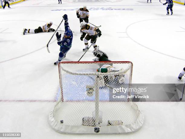 Raffi Torres of the Vancouver Canucks scores with 18 seconds left to go in the third period while Tim Thomas, Chris Kelly, Milan Lucic, Zdeno Chara...