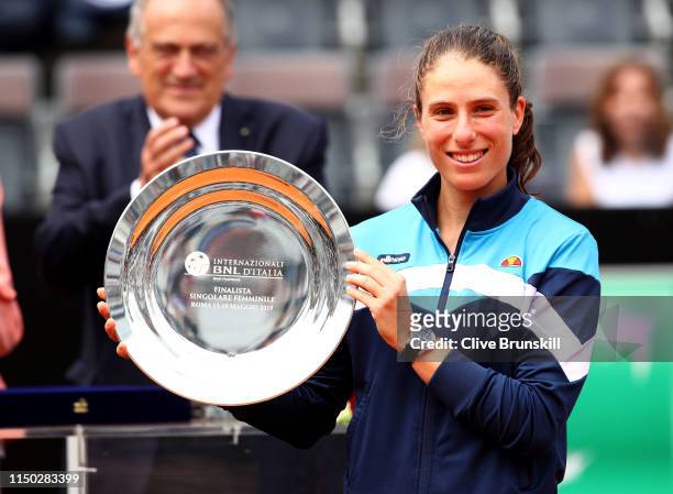 Johanna Konta of Great Britain holds her runners up trophy after her straight sets defeat against Karolina Pliskova of the Czech Republic in the...