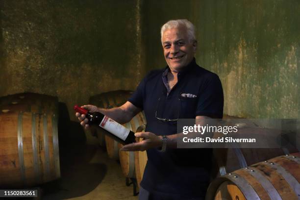 Veteran Argentinian winemaker Carmelo Patti shows a bottle of his 2010 vintage Cabernet Sauvignon wine in the cellar of his eponymous Bodega Carmelo...