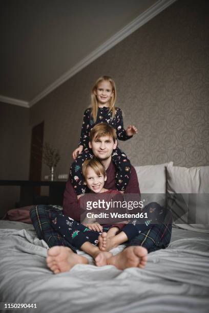 family portrait of father and two children at home - family formal portrait stock pictures, royalty-free photos & images