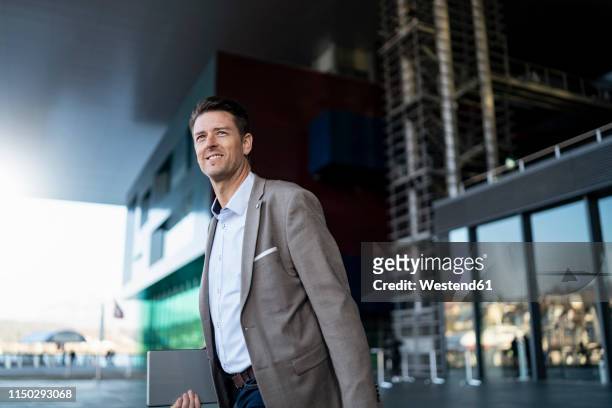 smiling businessman on the move in the city - switzerland business stock pictures, royalty-free photos & images