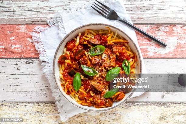 bowl of pasta with aubergine tomato sugo garnished with pine nuts, parmesan and basil - sugo pomodoro stock pictures, royalty-free photos & images