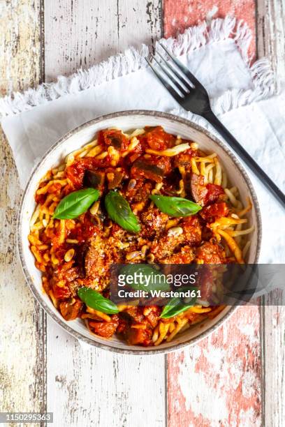 bowl of pasta with aubergine tomato sugo garnished with pine nuts, parmesan and basil - sugo pomodoro stock pictures, royalty-free photos & images