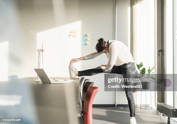 businesswoman stretching in office - stretching stock pictures, royalty-free photos & images