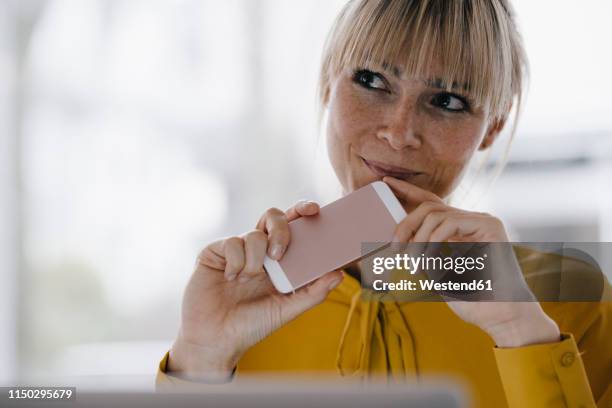 portrait of a beautiful blond woman, smiling - daydreaming woman stock-fotos und bilder