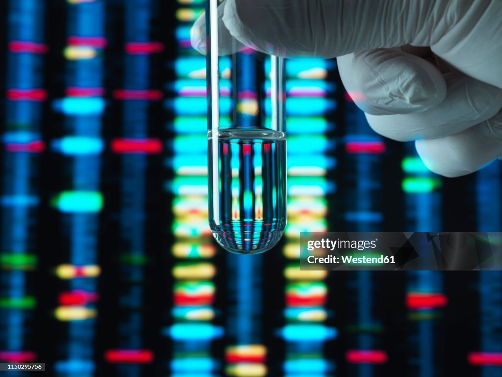 Genetic Research, DNA profile reflected in a test tube containing a sample