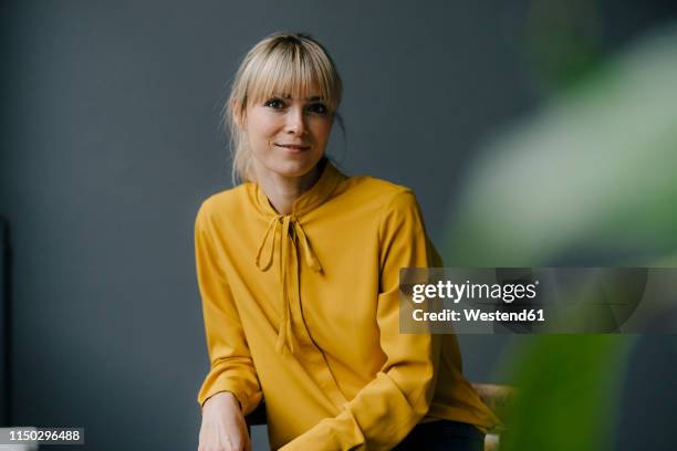 portrait of a serene blond woman - female executive portrait stock pictures, royalty-free photos & images