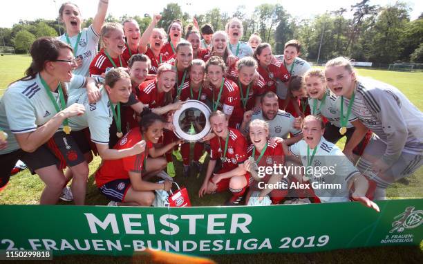 Players of Muenchen celebrate with the trophy after winning the title after the 2. Frauen Bundesliga match between TSG 1899 Hoffenheim II and FC...