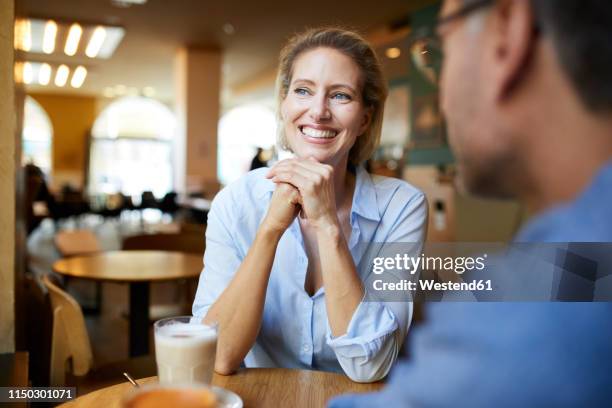 portrait of happy woman with man in a cafe - leisure work coffee happy stockfoto's en -beelden