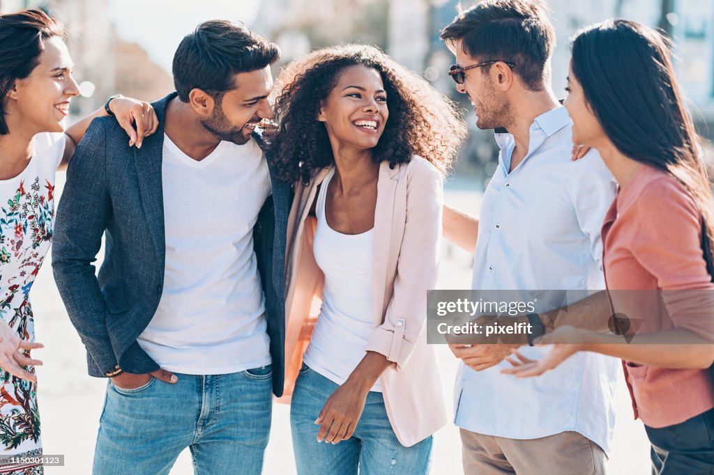 Multi-ethnic group of cheerful young people in the city