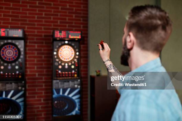 man playing darts - man darts stock pictures, royalty-free photos & images