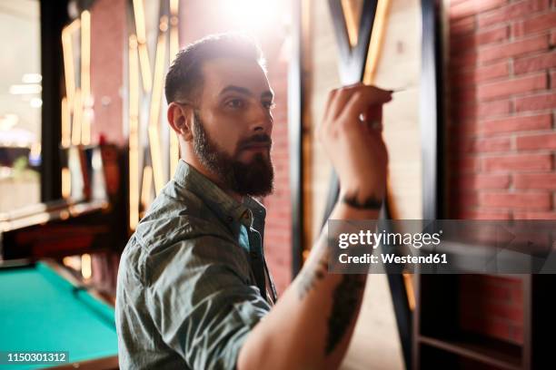 portrait of man playing darts - throwing darts stock pictures, royalty-free photos & images