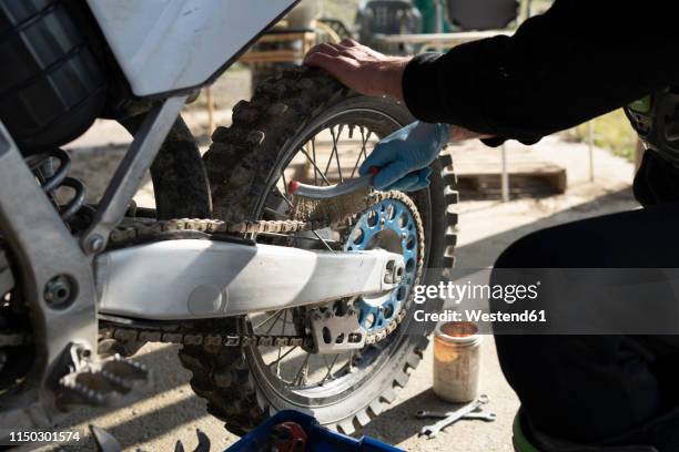 close-up of man working on motocross bike - the moto x film experience stock-fotos und bilder