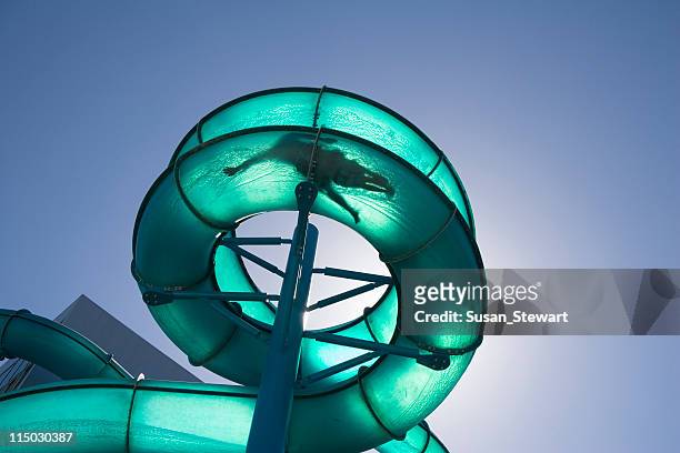 waterslide, backlit - water park stock pictures, royalty-free photos & images