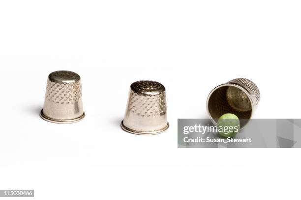 pea and thimble trick - thimble stock pictures, royalty-free photos & images