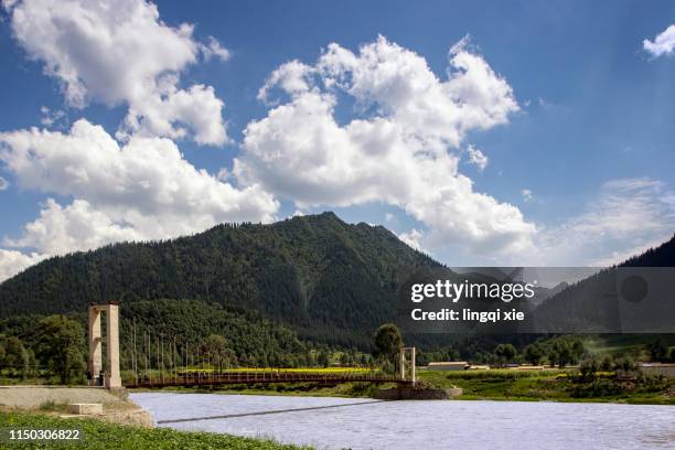 bridge in the qinghai-tibet plateau valley in western china - provinz qinghai stock-fotos und bilder