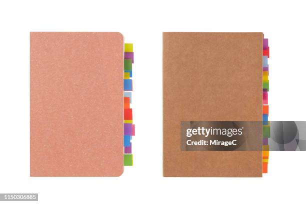 colorful tags at the edge of note pad - segnalibro foto e immagini stock