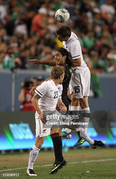 Aldo De Nigris of Mexico battles for the ball against David McGlinchey and Andrew Boyens of New Zealand at INVESCO Field at Mile High on June 1, 2011...