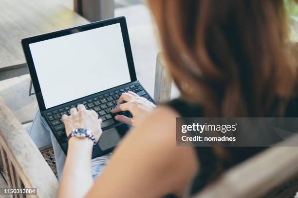 blank screen laptop mock up,woman typing laptop keyboard. - blank laptop screen stock-fotos und bilder